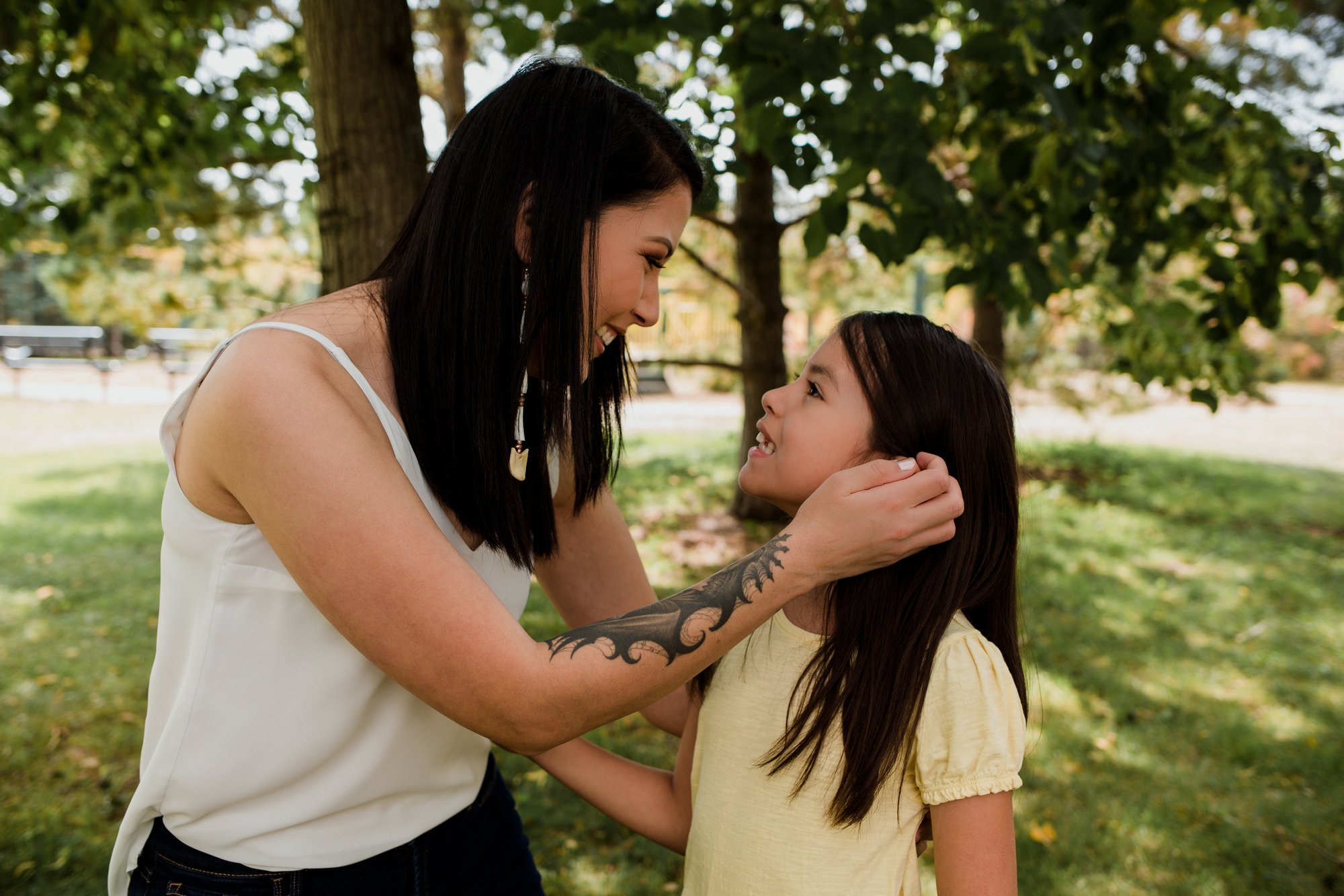 mother-looks-at-child-and-moves-their-hair